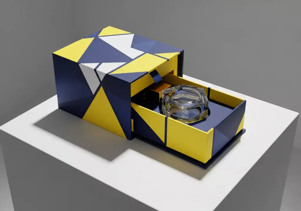 Kemasan parfum unik model sliding box dengan pola geometris kuning dan biru.
